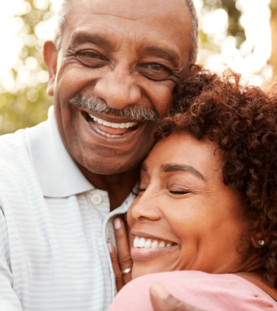 husband and wife hugging and smiling - dentaluxe
