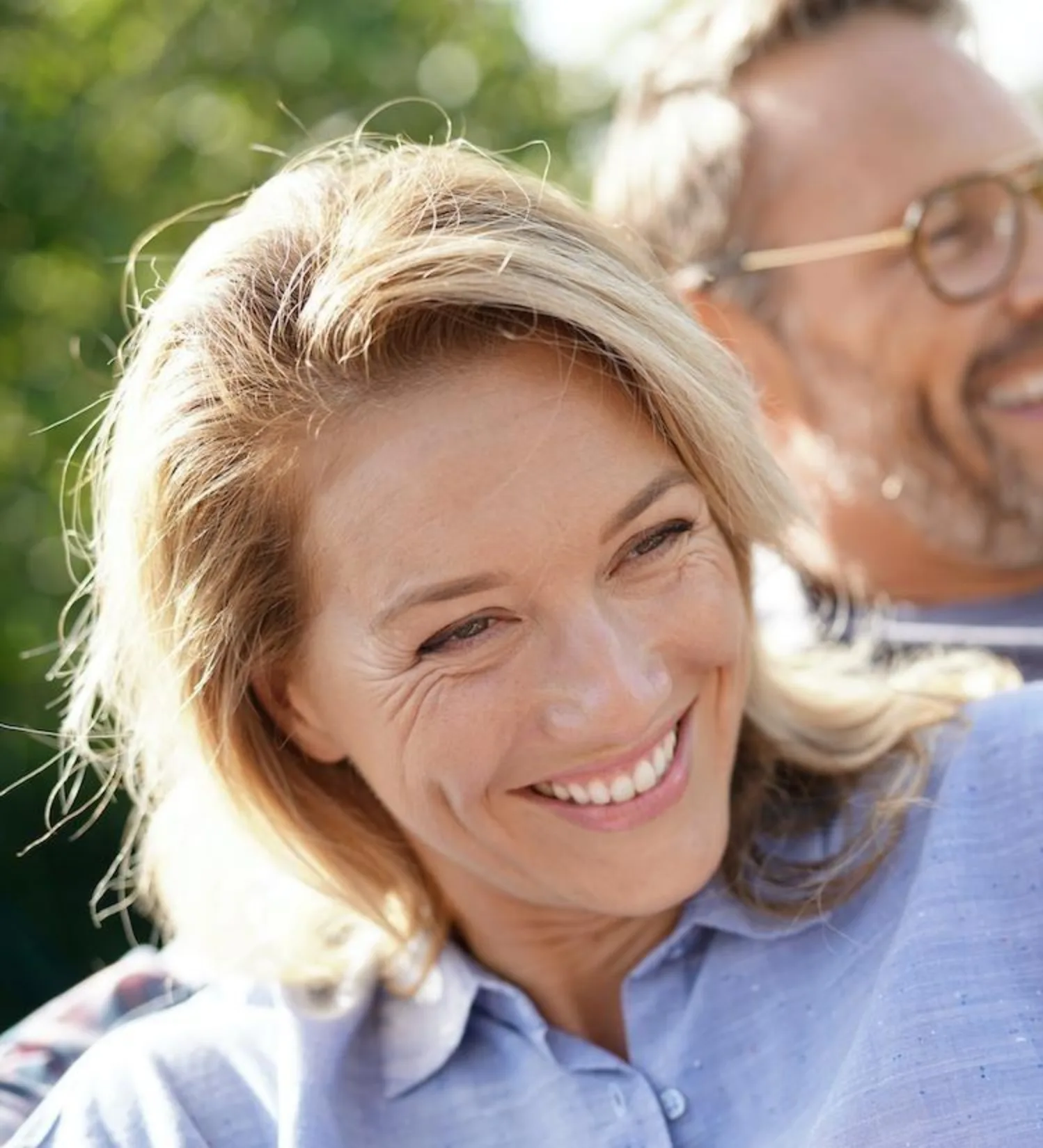 woman in purple shirt smiling - dentaluxe