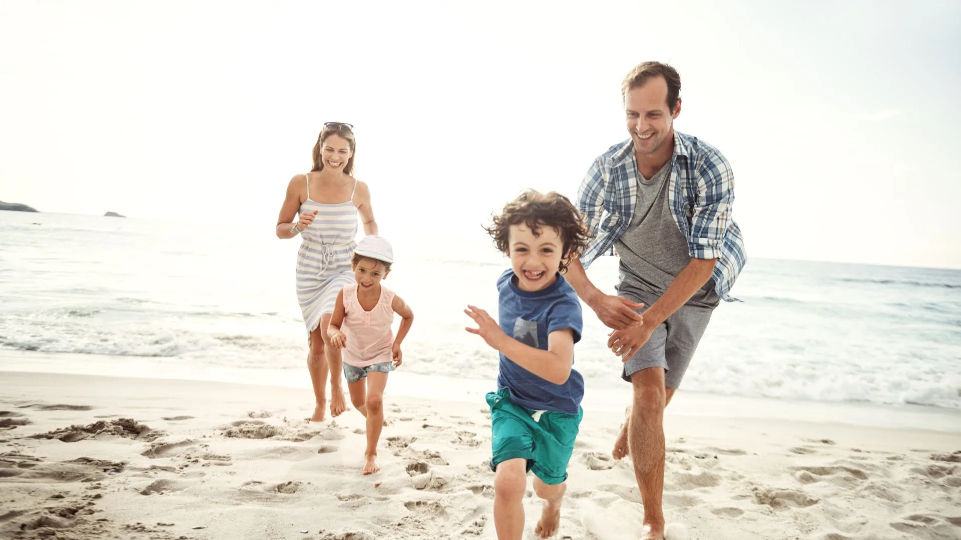 family runs on beach learning facts about gum disease