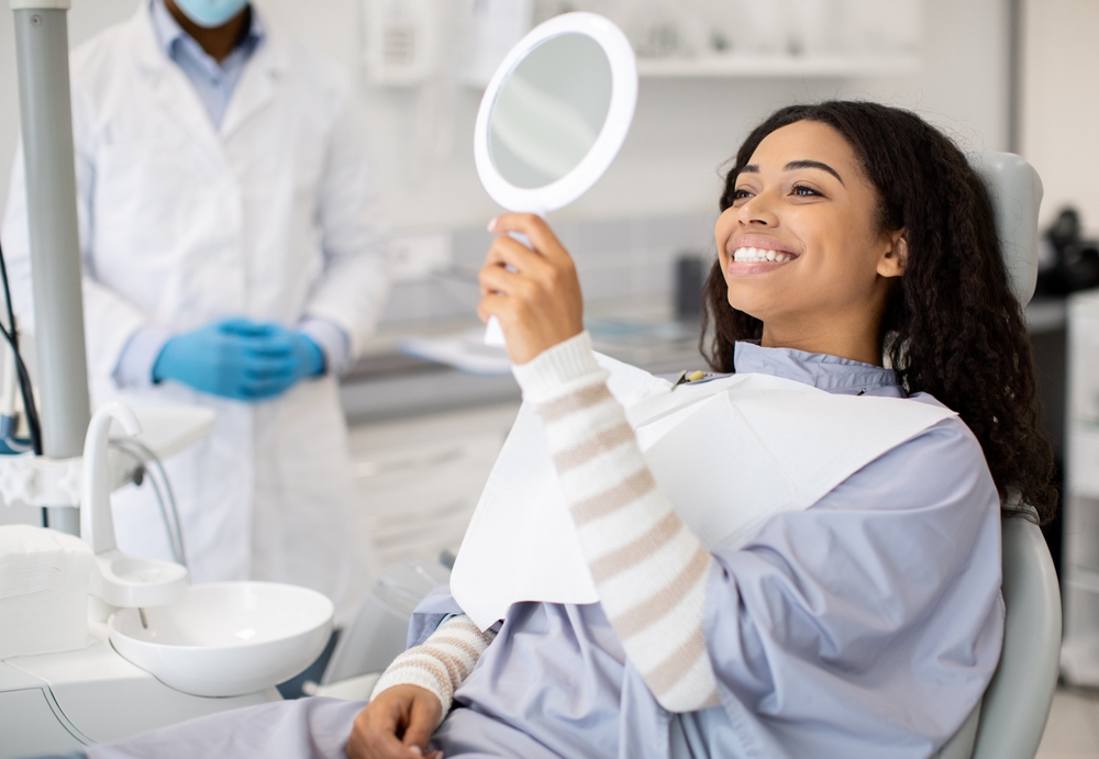 Dentist consulting with a patient about dental implants in a modern office
